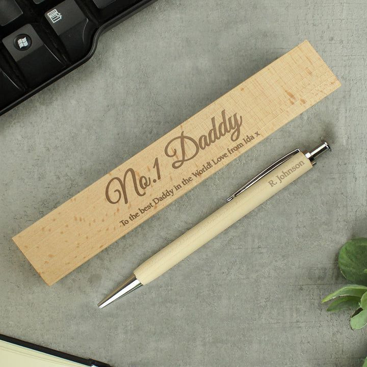 Personalised wooden pen beside its engraved wooden gift box